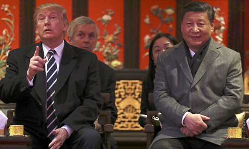 Tổng thống Mỹ Donald Trump (trái) và Chủ tịch Trung Quốc Tập Cận Bình trong cuộc gặp tại Bắc Kinh năm 2017. Ảnh: AP.