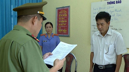 Ông Trần Xuân Yến nghe công an tống đạt quyết định khởi tố tháng 7/2018.